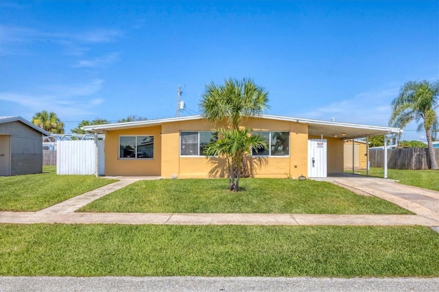 210 Duxbury Ave, Port Charlotte, FL 33952 - view of front facade with concrete driveway, an attached carport, and stucco siding