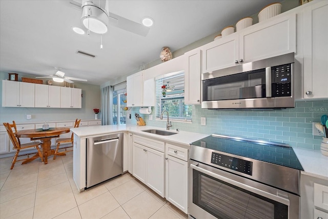 10341 Greenway Ave, Englewood, FL 34224 - kitchen featuring appliances with stainless steel finishes, ceiling fan, decorative backsplash, and light countertops