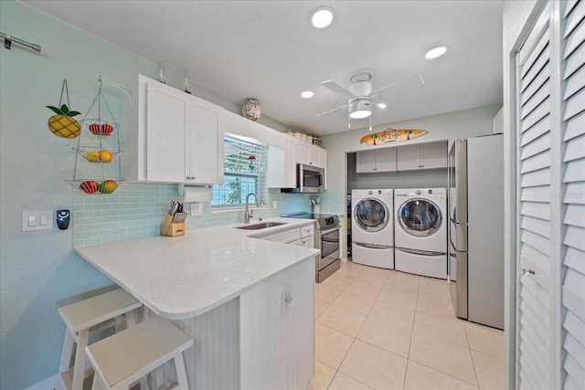 10341 Greenway Ave, Englewood, FL 34224 - laundry area with washing machine and clothes dryer, ceiling fan, light tile patterned floors, and recessed lighting