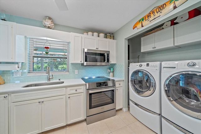 10341 Greenway Ave, Englewood, FL 34224 - laundry area featuring washing machine and dryer and light tile patterned floors
