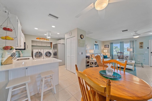 10341 Greenway Ave, Englewood, FL 34224 - dining area with independent washer and dryer, a ceiling fan, light tile patterned floors, and recessed lighting