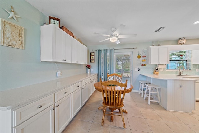10341 Greenway Ave, Englewood, FL 34224 - kitchen with light countertops, healthy amount of natural light, and white cabinetry