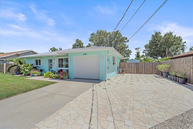 10341 Greenway Ave, Englewood, FL 34224 - ranch-style house with a garage, driveway, and stucco siding