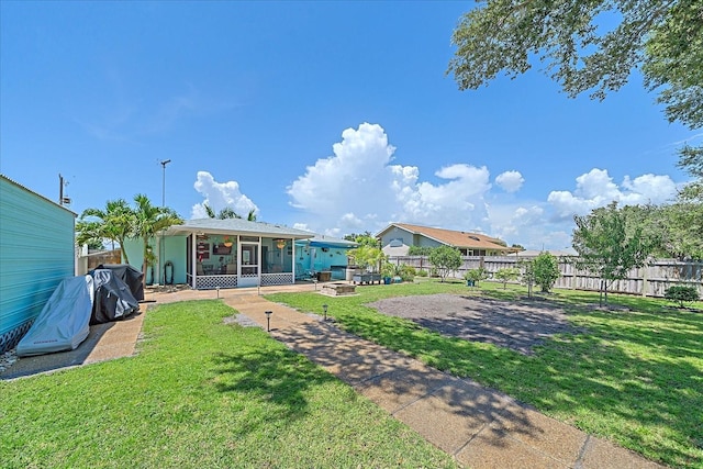 10341 Greenway Ave, Englewood, FL 34224 - fenced backyard with a sunroom and an outdoor fire pit