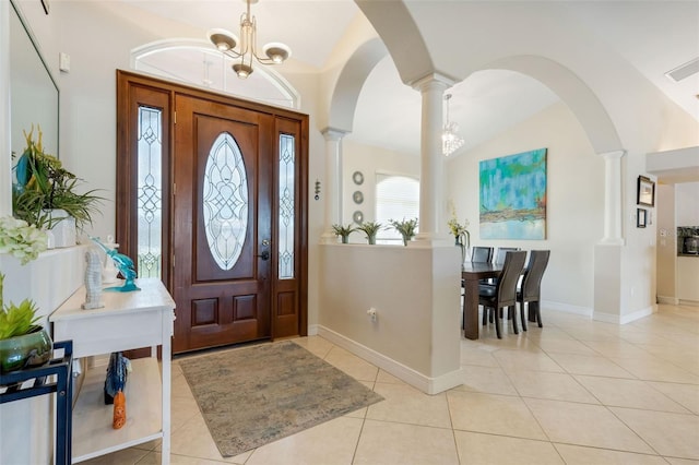 5001 Almar Dr, Punta Gorda, FL 33950 - foyer entrance with ornate columns, light tile patterned floors, arched walkways, vaulted ceiling, and a chandelier