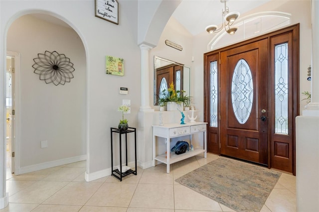 5001 Almar Dr, Punta Gorda, FL 33950 - foyer entrance with arched walkways, decorative columns, light tile patterned floors, and a chandelier