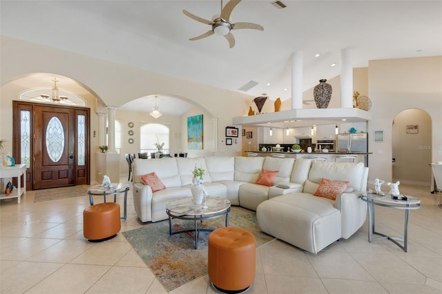 5001 Almar Dr, Punta Gorda, FL 33950 - living area with arched walkways, a ceiling fan, light tile patterned flooring, ornate columns, and high vaulted ceiling