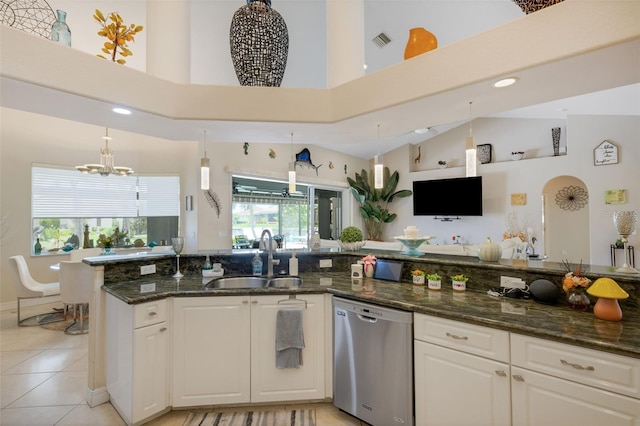 5001 Almar Dr, Punta Gorda, FL 33950 - kitchen with stainless steel dishwasher, white cabinets, a chandelier, dark stone countertops, and high vaulted ceiling