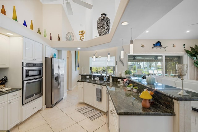 5001 Almar Dr, Punta Gorda, FL 33950 - kitchen with appliances with stainless steel finishes, ceiling fan, white cabinets, light tile patterned floors, and dark stone counters