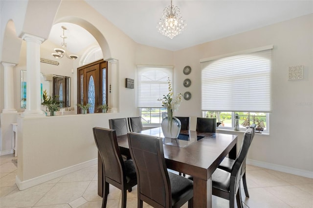 5001 Almar Dr, Punta Gorda, FL 33950 - dining area featuring a chandelier, ornate columns, light tile patterned floors, plenty of natural light, and lofted ceiling