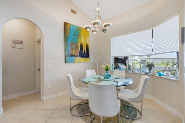 5001 Almar Dr, Punta Gorda, FL 33950 - dining space with arched walkways, tile patterned floors, a chandelier, and vaulted ceiling