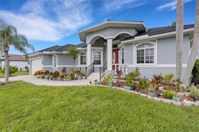 5001 Almar Dr, Punta Gorda, FL 33950 - ranch-style house featuring a garage, a front yard, covered porch, and stucco siding