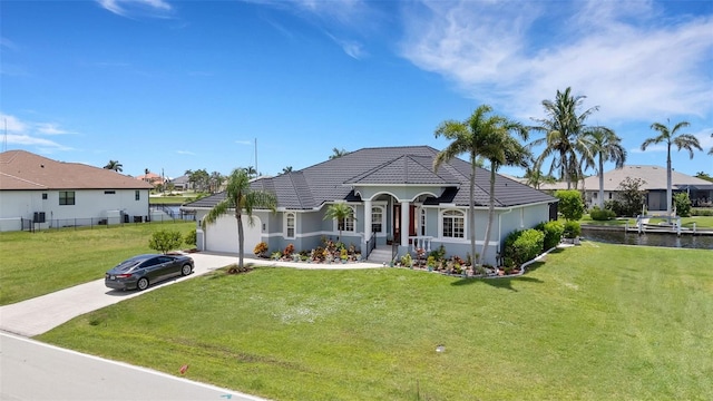 5001 Almar Dr, Punta Gorda, FL 33950 - view of front of property with driveway, an attached garage, a front lawn, a residential view, and a water view