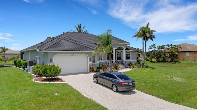 5001 Almar Dr, Punta Gorda, FL 33950 - view of front of property featuring a garage, decorative driveway, stucco siding, and a front yard