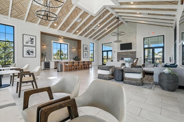 18525 Midsummer Pl, Venice, FL 34293 - living room with beverage cooler, high vaulted ceiling, healthy amount of natural light, light tile patterned floors, and beamed ceiling