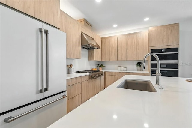 18525 Midsummer Pl, Venice, FL 34293 - kitchen featuring appliances with stainless steel finishes, light brown cabinetry, light countertops, range hood, and recessed lighting