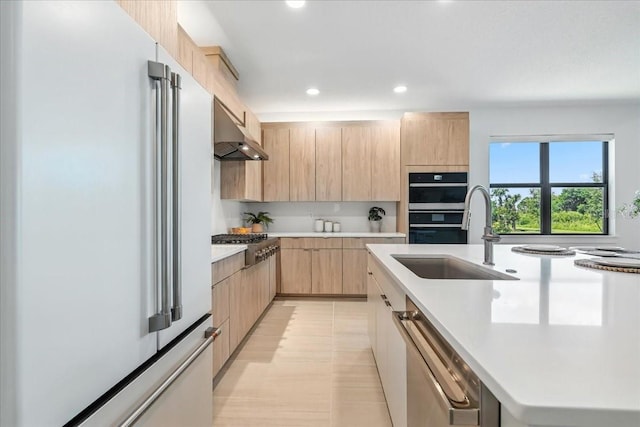 18525 Midsummer Pl, Venice, FL 34293 - kitchen with stainless steel appliances, light brown cabinetry, under cabinet range hood, modern cabinets, and light countertops
