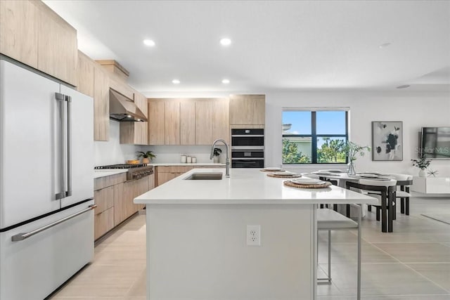 18525 Midsummer Pl, Venice, FL 34293 - kitchen with appliances with stainless steel finishes, light brown cabinetry, range hood, modern cabinets, and recessed lighting