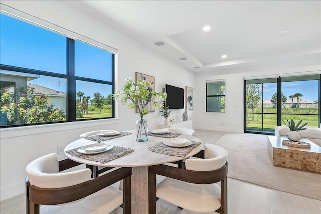 18525 Midsummer Pl, Venice, FL 34293 - dining area with light wood-style floors, recessed lighting, and a raised ceiling