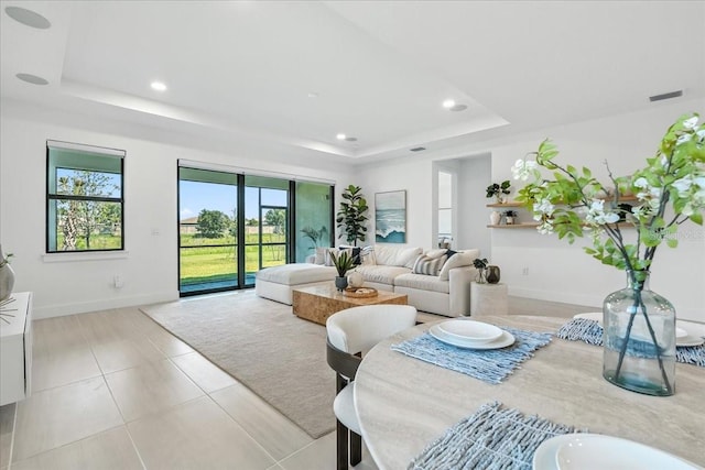 18525 Midsummer Pl, Venice, FL 34293 - living area with a tray ceiling, recessed lighting, and light tile patterned floors