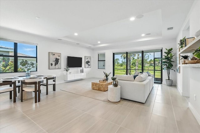 18525 Midsummer Pl, Venice, FL 34293 - living area featuring a raised ceiling, light tile patterned floors, and recessed lighting