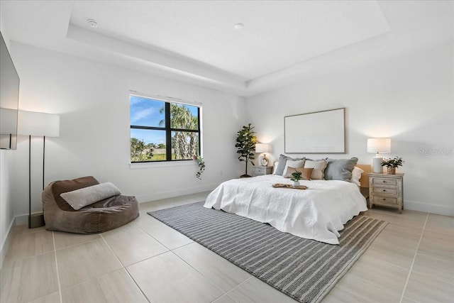 18525 Midsummer Pl, Venice, FL 34293 - bedroom with a raised ceiling and light tile patterned flooring