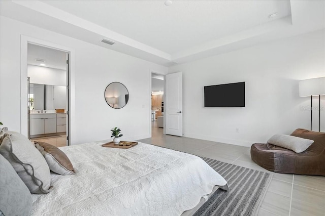 18525 Midsummer Pl, Venice, FL 34293 - tiled bedroom featuring ensuite bath and a raised ceiling