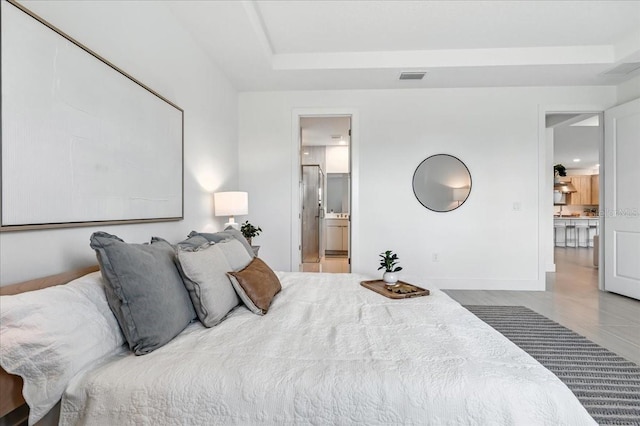 18525 Midsummer Pl, Venice, FL 34293 - bedroom with a tray ceiling and ensuite bath