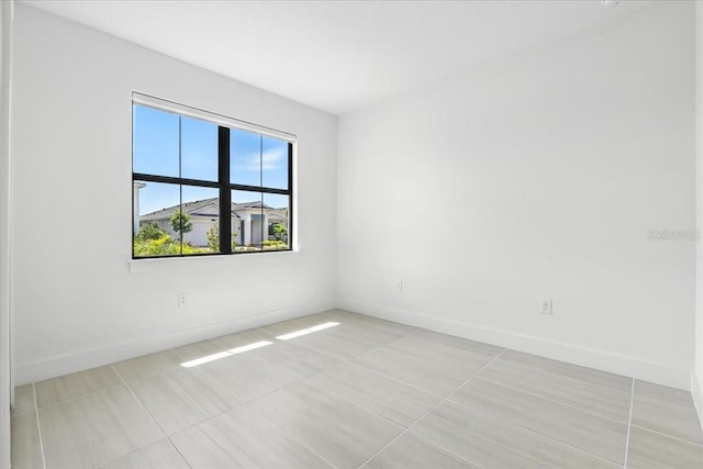 18525 Midsummer Pl, Venice, FL 34293 - unfurnished room with light tile patterned flooring and baseboards
