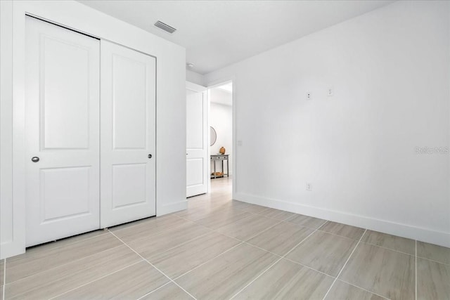 18525 Midsummer Pl, Venice, FL 34293 - unfurnished bedroom with a closet and baseboards