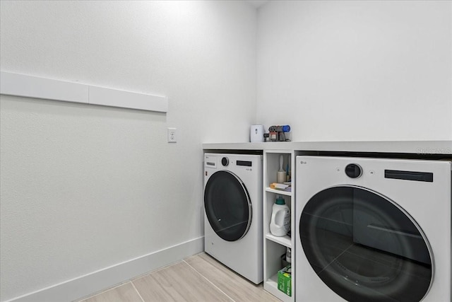 18525 Midsummer Pl, Venice, FL 34293 - laundry area with washing machine and clothes dryer and light wood-style floors
