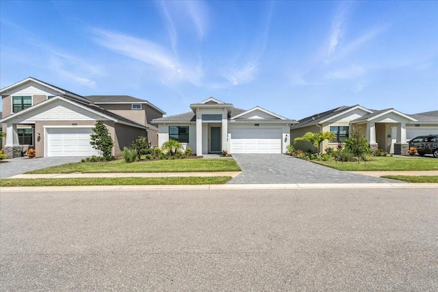 18525 Midsummer Pl, Venice, FL 34293 - view of front facade featuring decorative driveway, an attached garage, stucco siding, and a front lawn