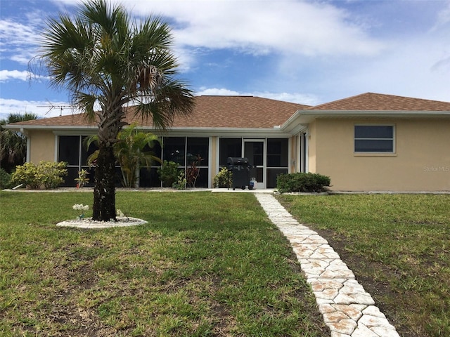 15140 Lyneburg Ave, Port Charlotte, FL 33981 - view of front facade featuring stucco siding, a sunroom, and a front yard