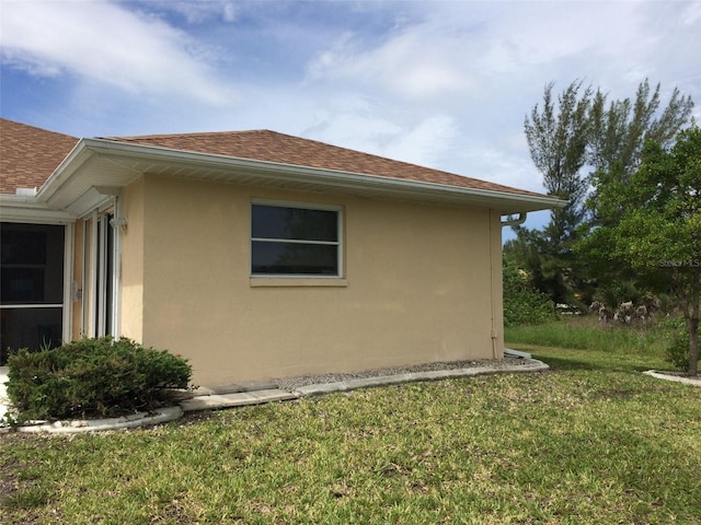 15140 Lyneburg Ave, Port Charlotte, FL 33981 - view of home's exterior featuring stucco siding, a yard, and roof with shingles