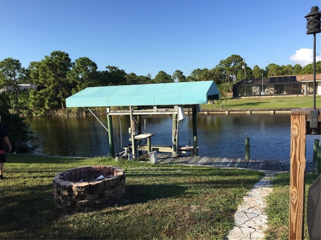 15140 Lyneburg Ave, Port Charlotte, FL 33981 - dock featuring a fire pit, boat lift, a yard, and a water view