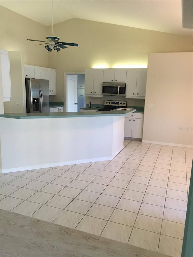 15140 Lyneburg Ave, Port Charlotte, FL 33981 - kitchen featuring appliances with stainless steel finishes, light tile patterned floors, high vaulted ceiling, a ceiling fan, and dark countertops