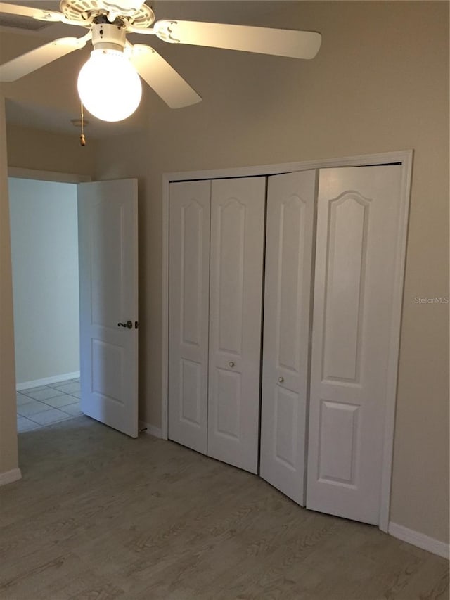 15140 Lyneburg Ave, Port Charlotte, FL 33981 - unfurnished bedroom featuring light wood-style floors, a closet, and ceiling fan