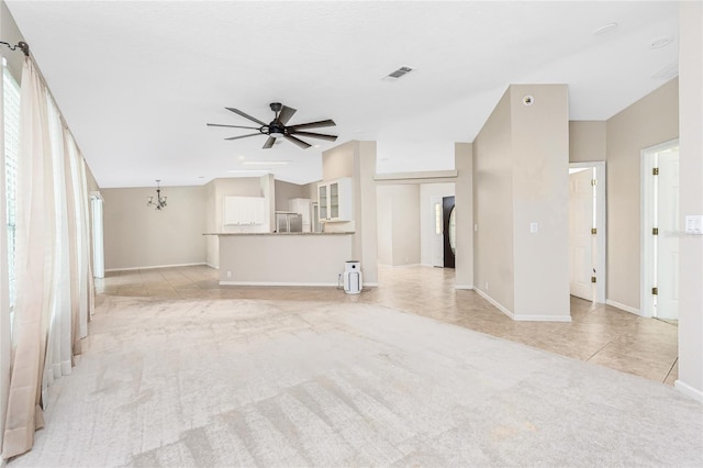 2631 S Cranberry Blvd, North Port, FL 34286 - unfurnished living room with light colored carpet, a ceiling fan, light tile patterned floors, and a chandelier