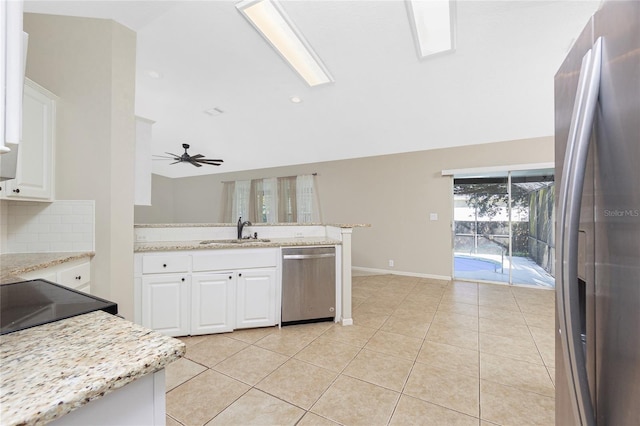 2631 S Cranberry Blvd, North Port, FL 34286 - kitchen featuring stainless steel appliances, decorative backsplash, white cabinets, lofted ceiling, and a peninsula