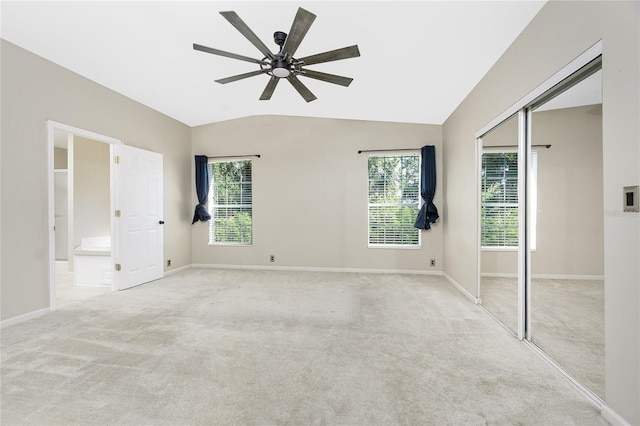 2631 S Cranberry Blvd, North Port, FL 34286 - unfurnished bedroom featuring carpet, multiple windows, a closet, lofted ceiling, and connected bathroom