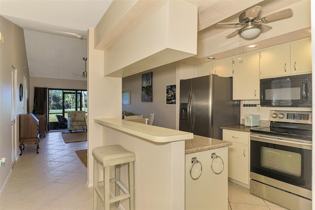 927 Capri Isles Blvd Unit 5, Venice, FL 34292 - kitchen featuring stainless steel electric stove, a ceiling fan, black microwave, light tile patterned flooring, and recessed lighting