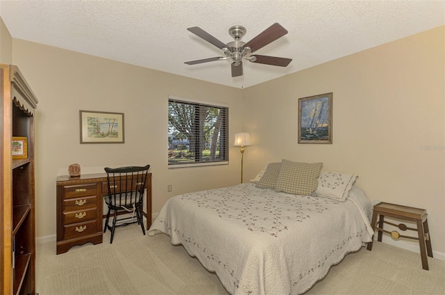 927 Capri Isles Blvd Unit 5, Venice, FL 34292 - bedroom with light carpet, a ceiling fan, and a textured ceiling