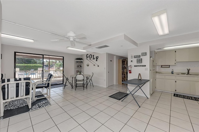 927 Capri Isles Blvd Unit 5, Venice, FL 34292 - kitchen with a ceiling fan, light tile patterned flooring, and freestanding refrigerator