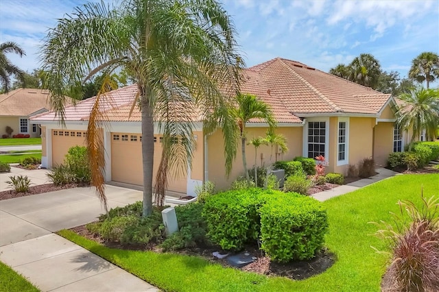 4841 Whispering Oaks Dr, North Port, FL 34287 - mediterranean / spanish house with stucco siding, driveway, a tile roof, an attached garage, and a front lawn
