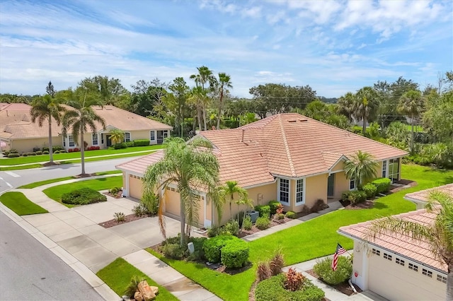4841 Whispering Oaks Dr, North Port, FL 34287 - mediterranean / spanish house with a tile roof, a front yard, driveway, and stucco siding