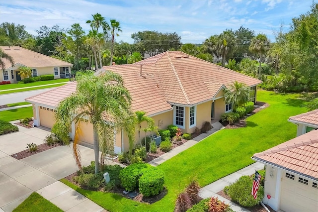 4841 Whispering Oaks Dr, North Port, FL 34287 - view of front of home with a tiled roof, concrete driveway, a front yard, stucco siding, and a garage