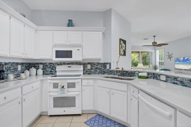 4841 Whispering Oaks Dr, North Port, FL 34287 - kitchen with white appliances, light tile patterned floors, decorative backsplash, and light countertops