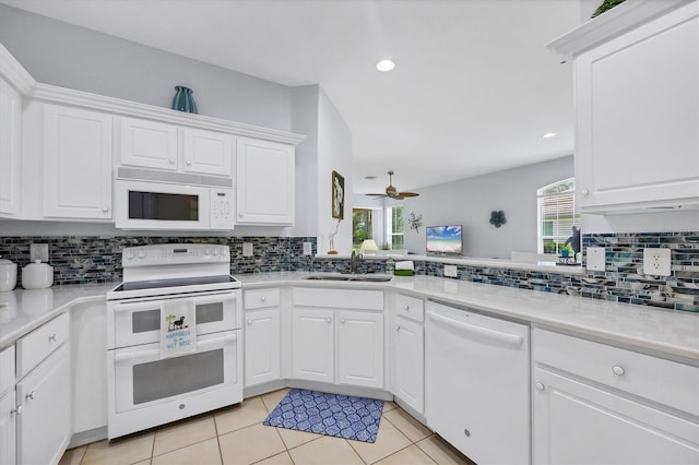 4841 Whispering Oaks Dr, North Port, FL 34287 - kitchen with white appliances, tasteful backsplash, light countertops, light tile patterned floors, and recessed lighting