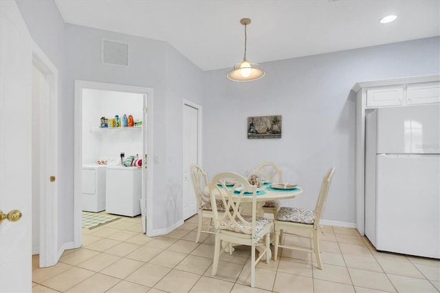 4841 Whispering Oaks Dr, North Port, FL 34287 - dining room with separate washer and dryer, arched walkways, and light tile patterned flooring