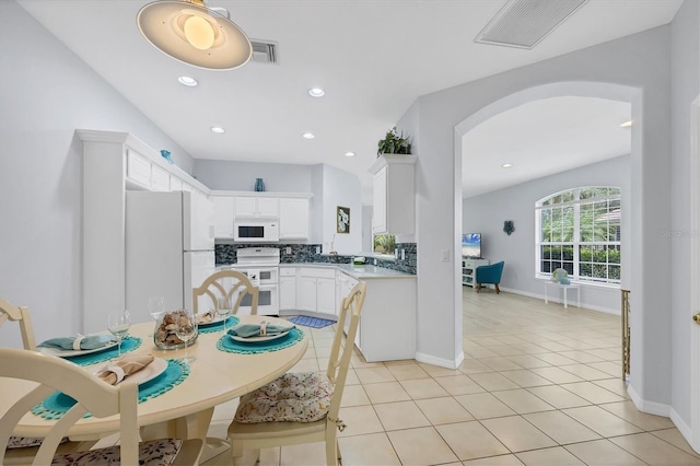 4841 Whispering Oaks Dr, North Port, FL 34287 - dining area featuring arched walkways, recessed lighting, and light tile patterned floors
